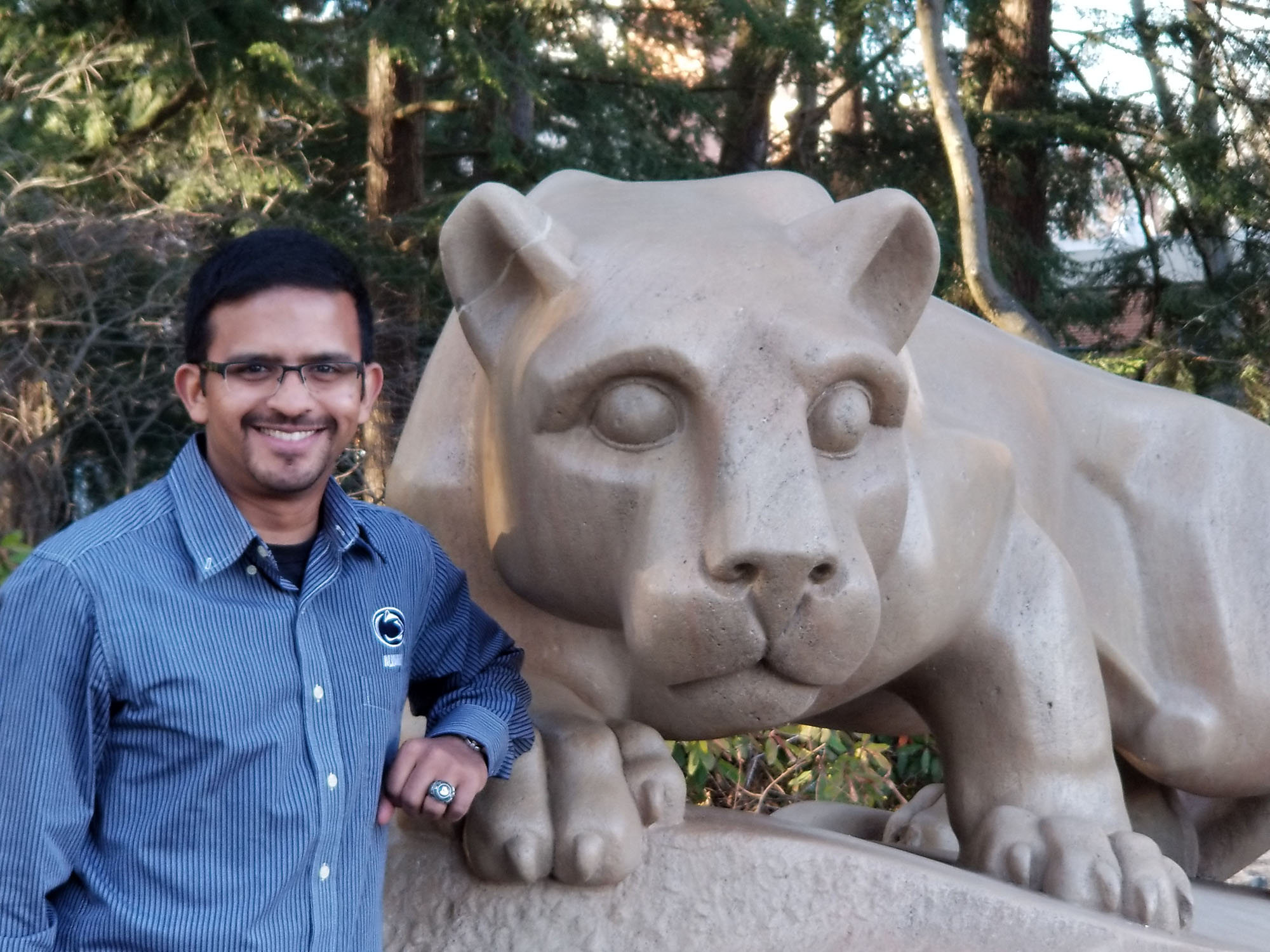 Pavara Ranatunga stands with the Nittany Lion shrine in the background