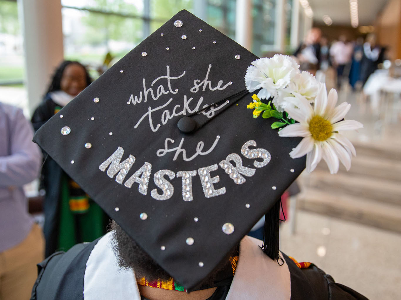 A 2023 SIA graduate decorated her cap with the words 'What she tackles, she masters.'