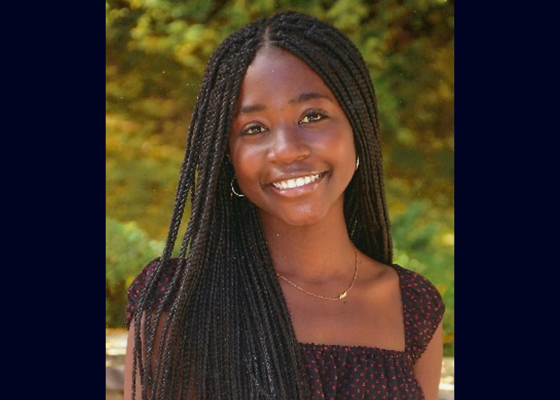 Photograph of Alexandria Warren in front of trees.