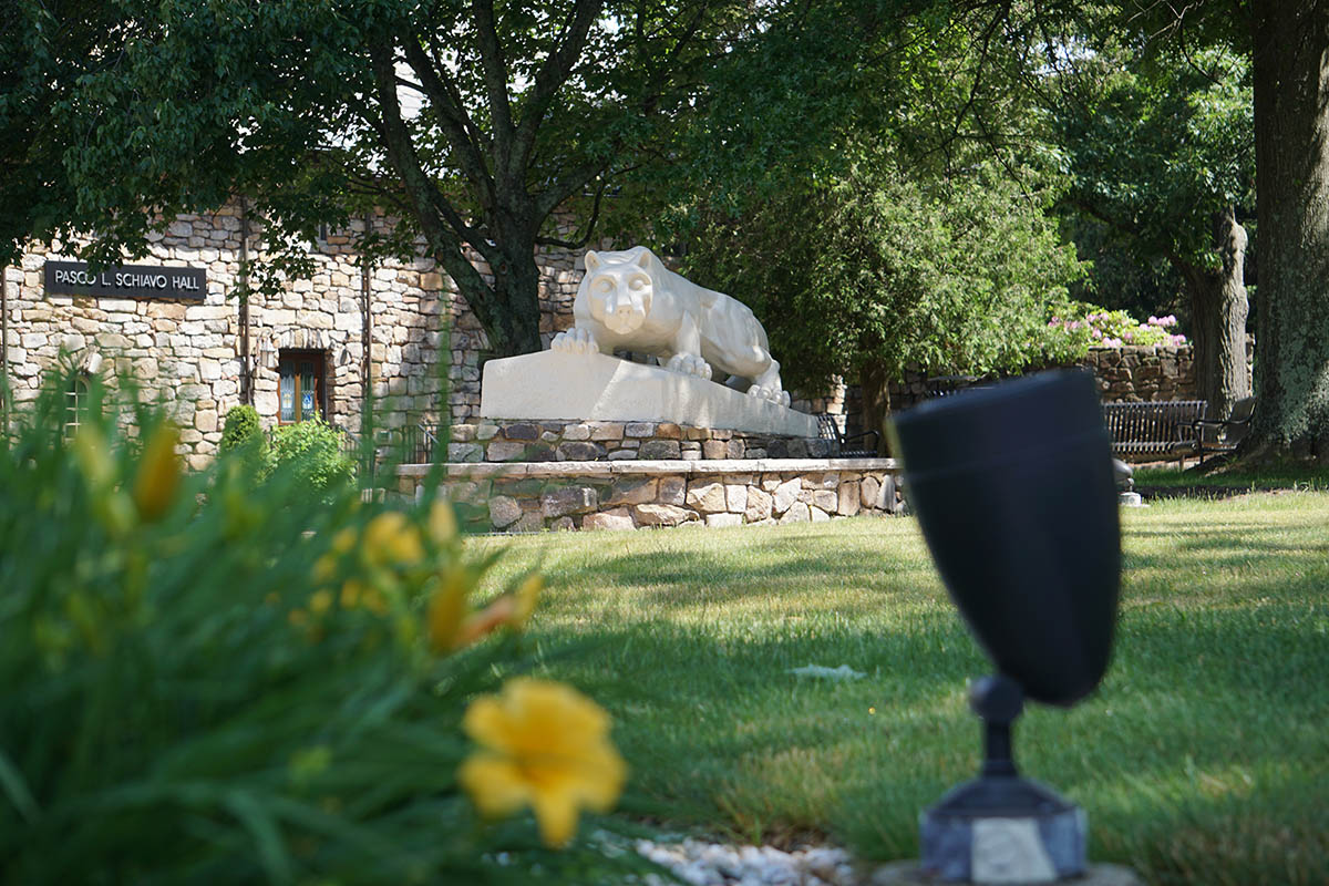 Nittany Lion statue in a field of green grass