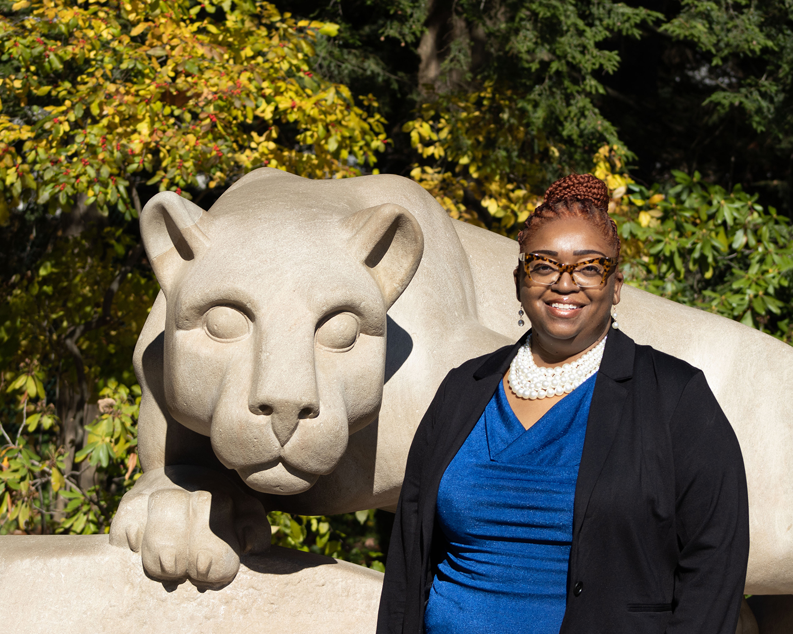 Dionne R. Wiggins poses in front of the Nittany Lion Shrine at the University Park campus.