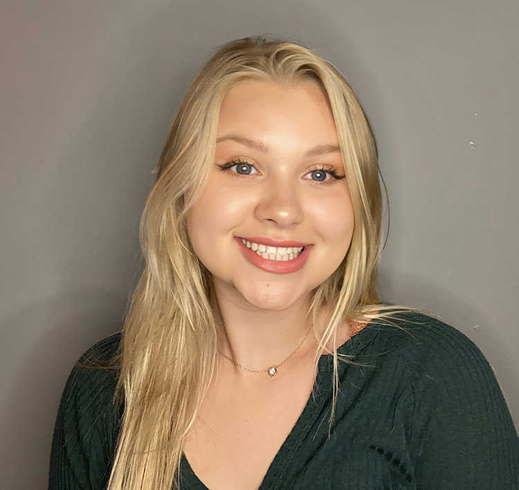 Smiling blond haired girl in a dark shirt