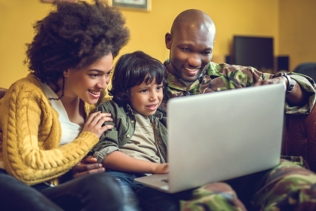 Military family looking at laptop computer