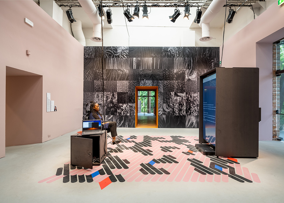 Felecia Davis sits in a hair salon chair in her display at the Venice Biennale. 