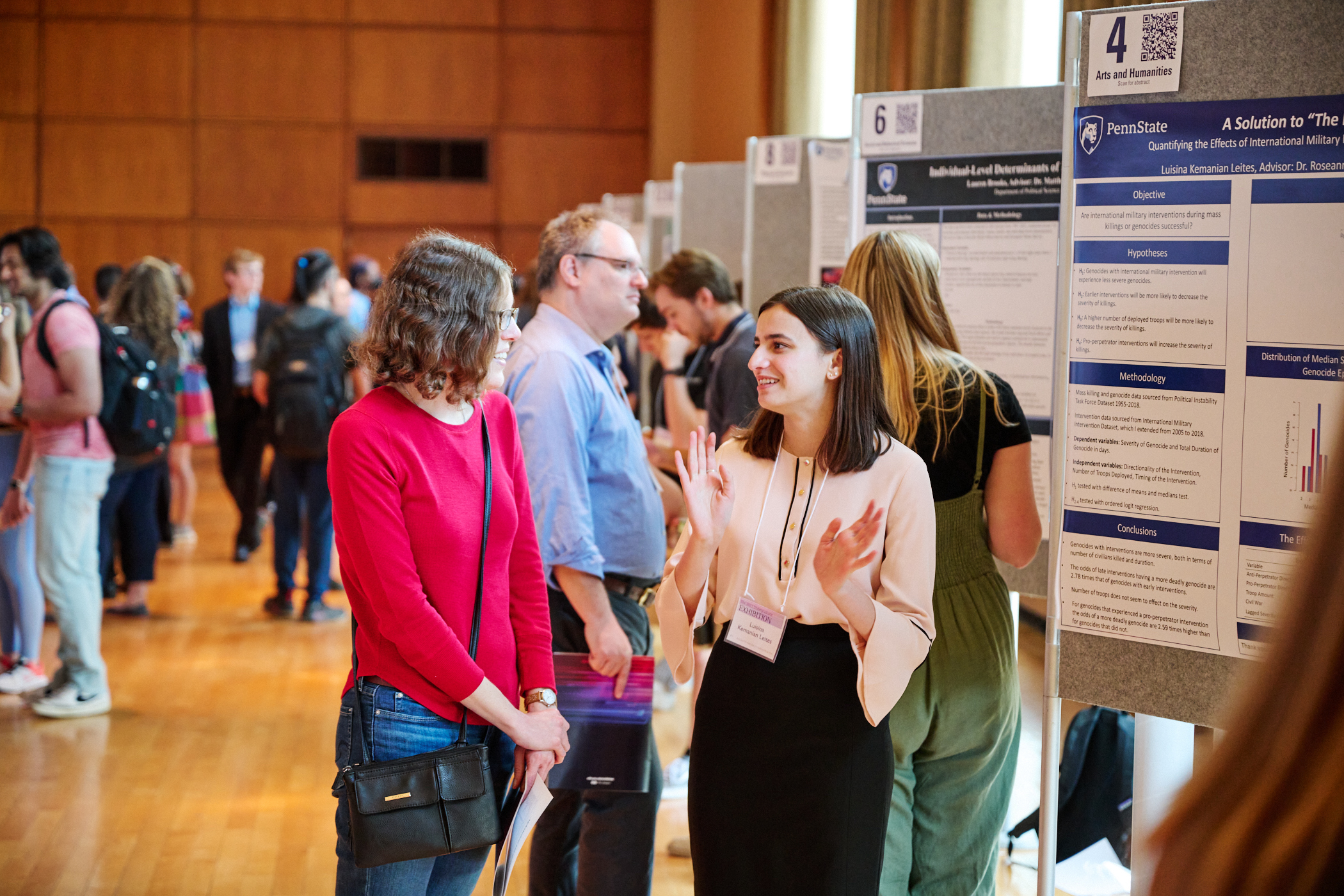 Student presenting research poster at academic exhibition