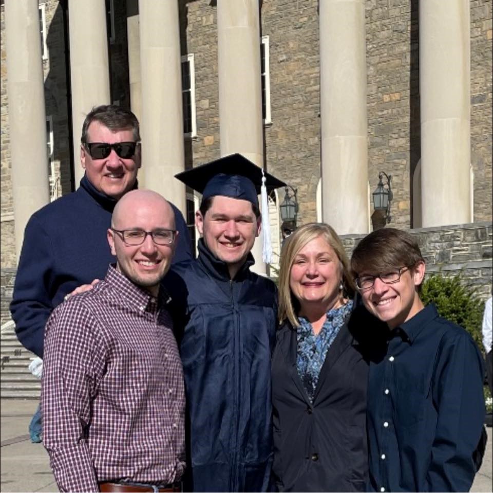 Bob '87 and Terese Martin stand on the steps of Old Main with their sons, Daniel, John, and Samuel.