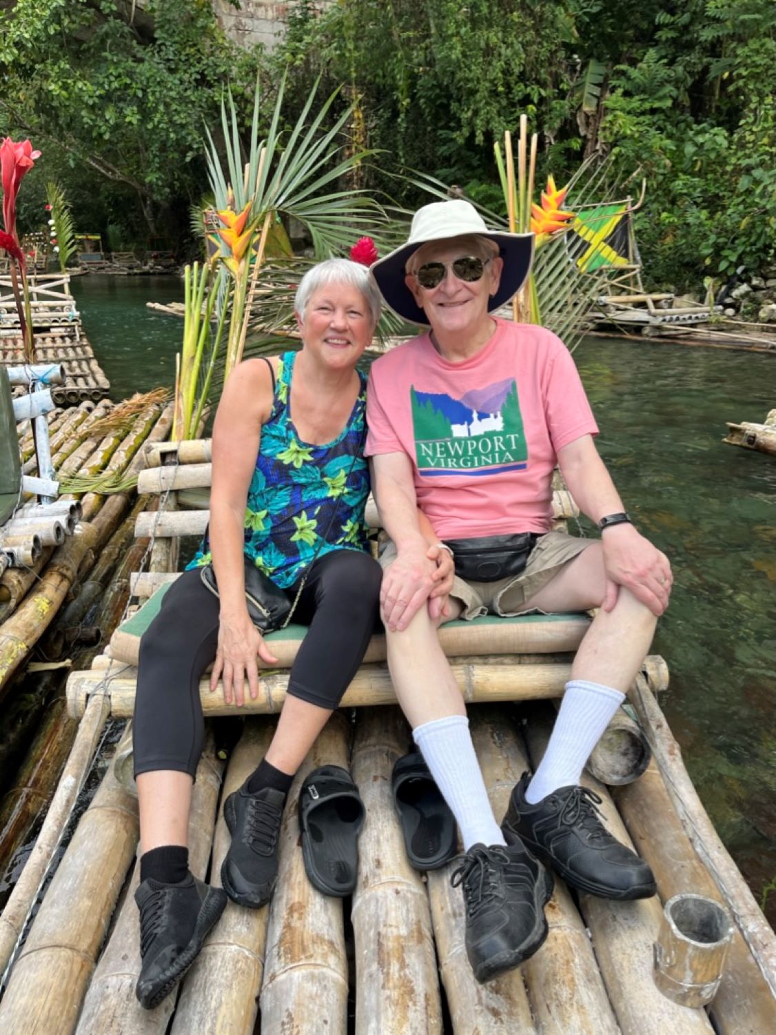 two people on wood raft in tropical setting