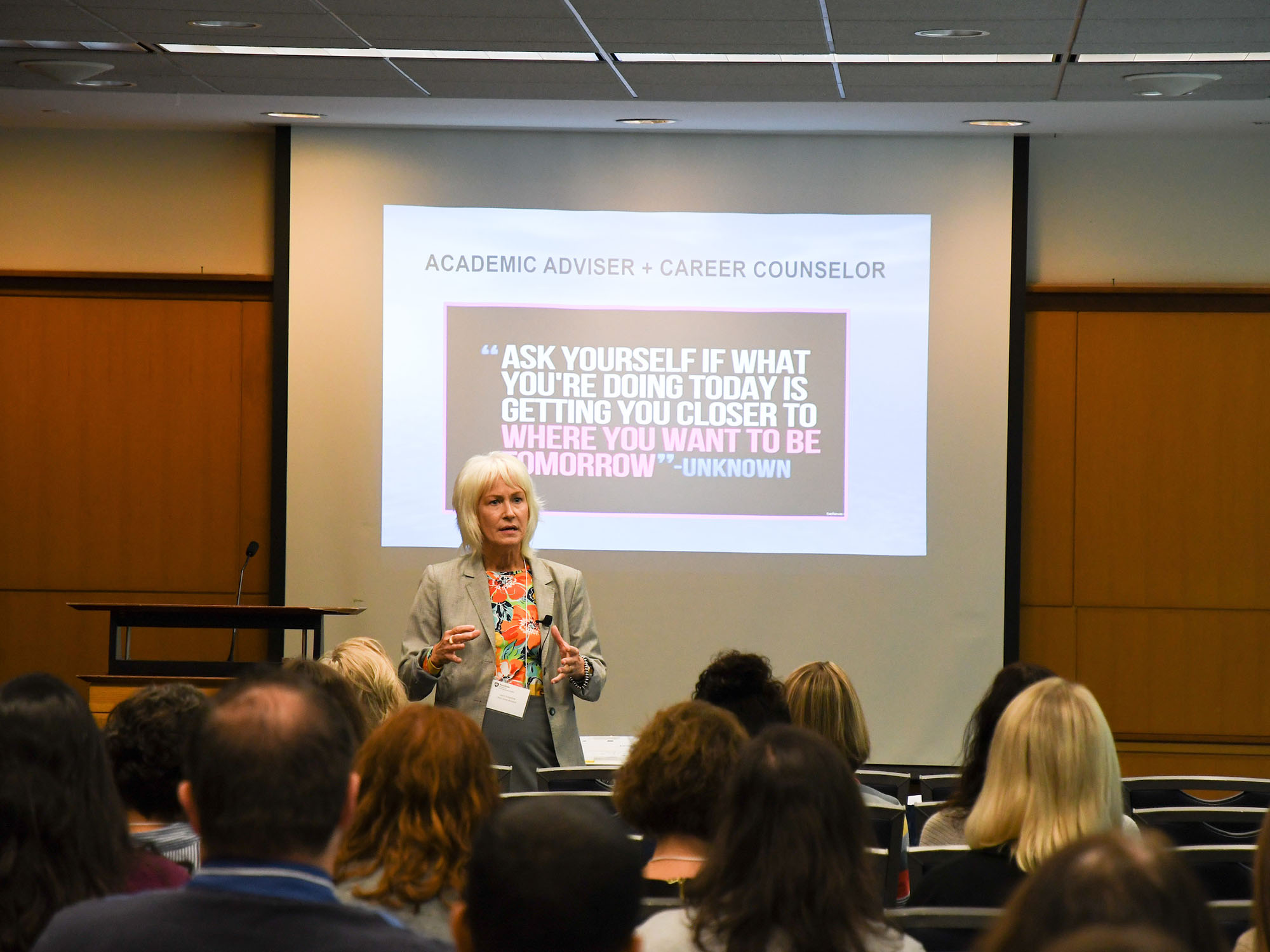 Presenter standing in front of audience giving presentation