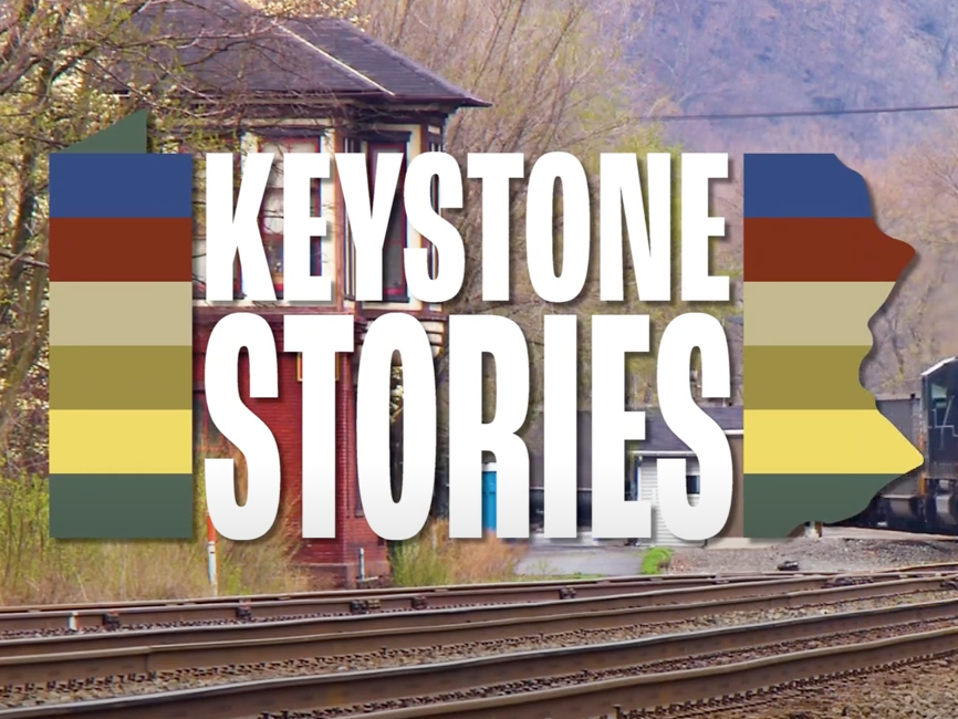 The words Keystone Stories over a photo of a locomotive on the tracks