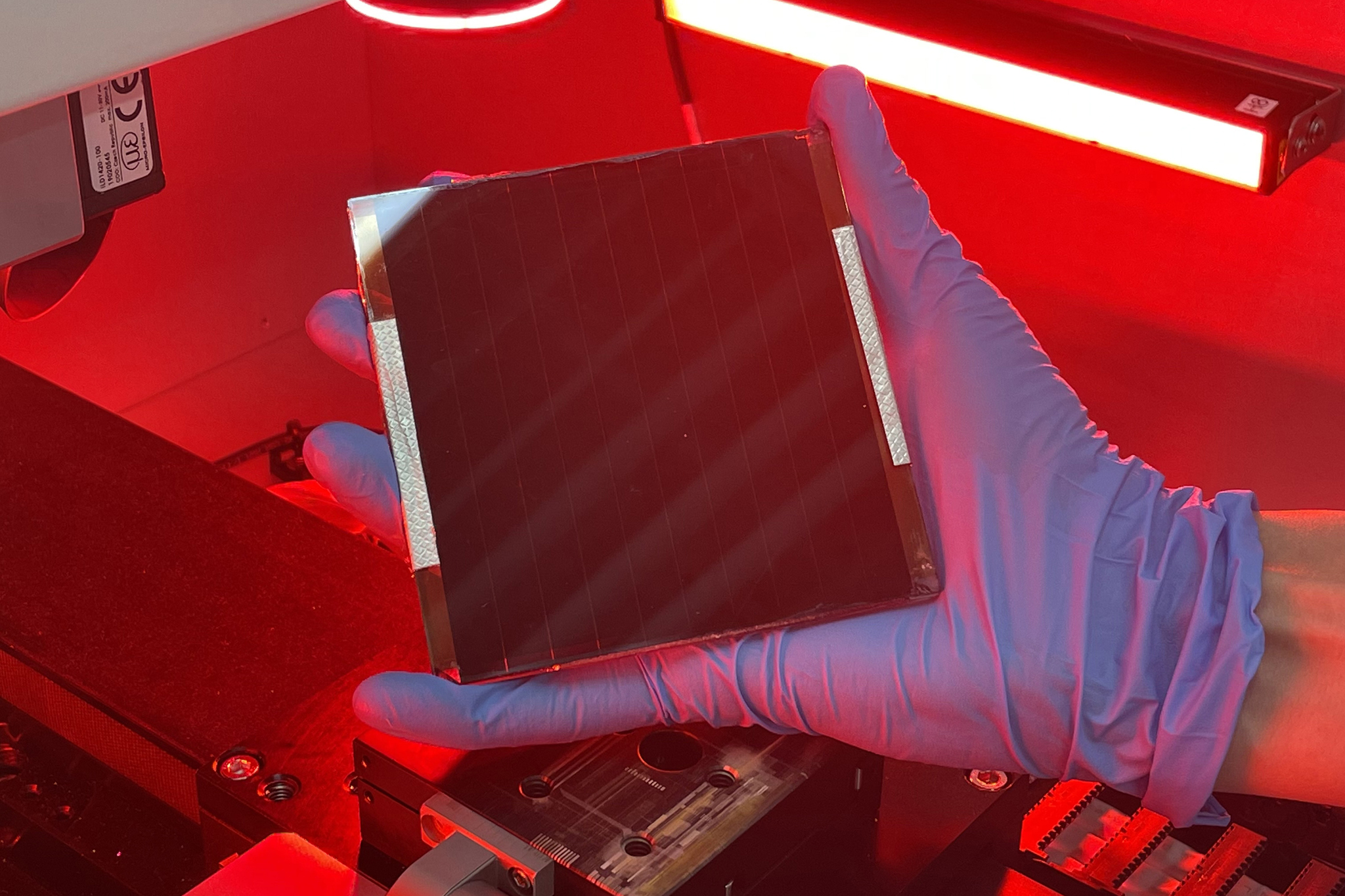 A researcher holds a bio-inspired solar device 