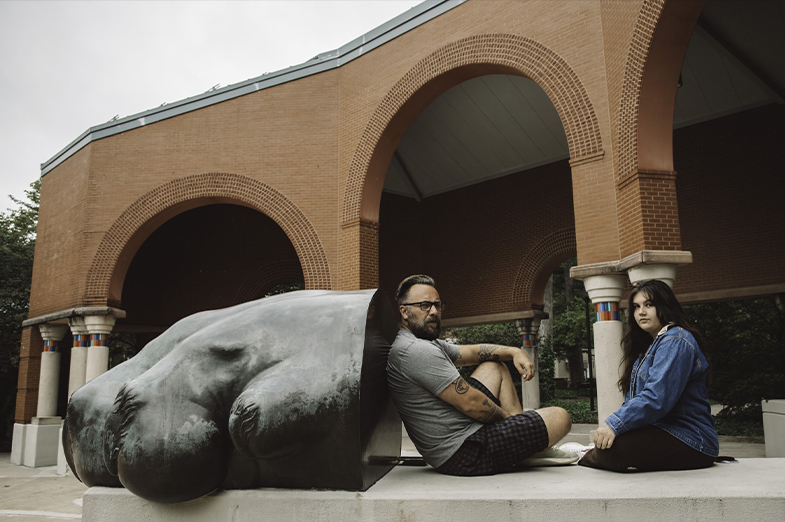 young woman and man sit side by side on penn state campus