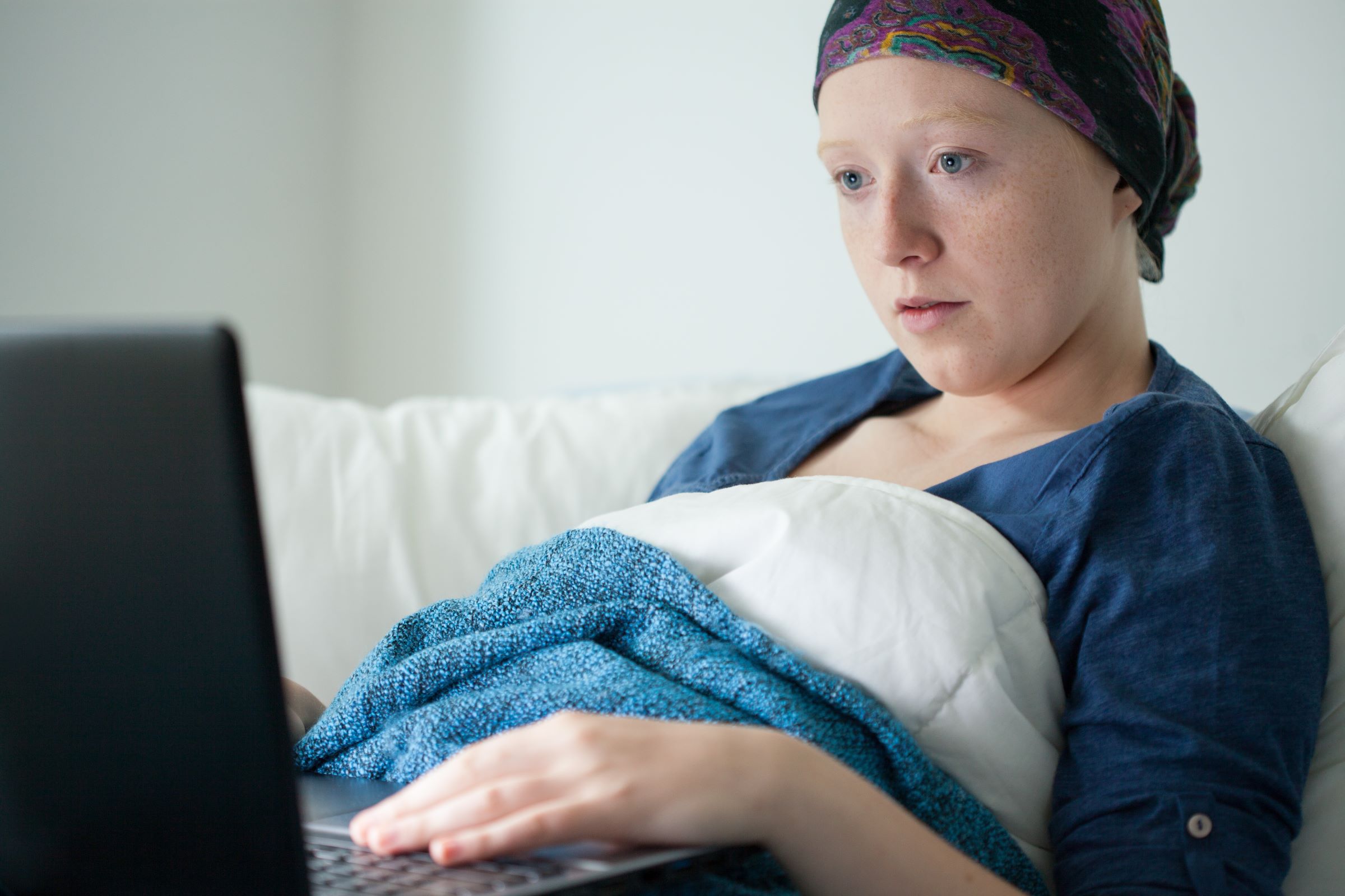 cancer patient browses laptop computer