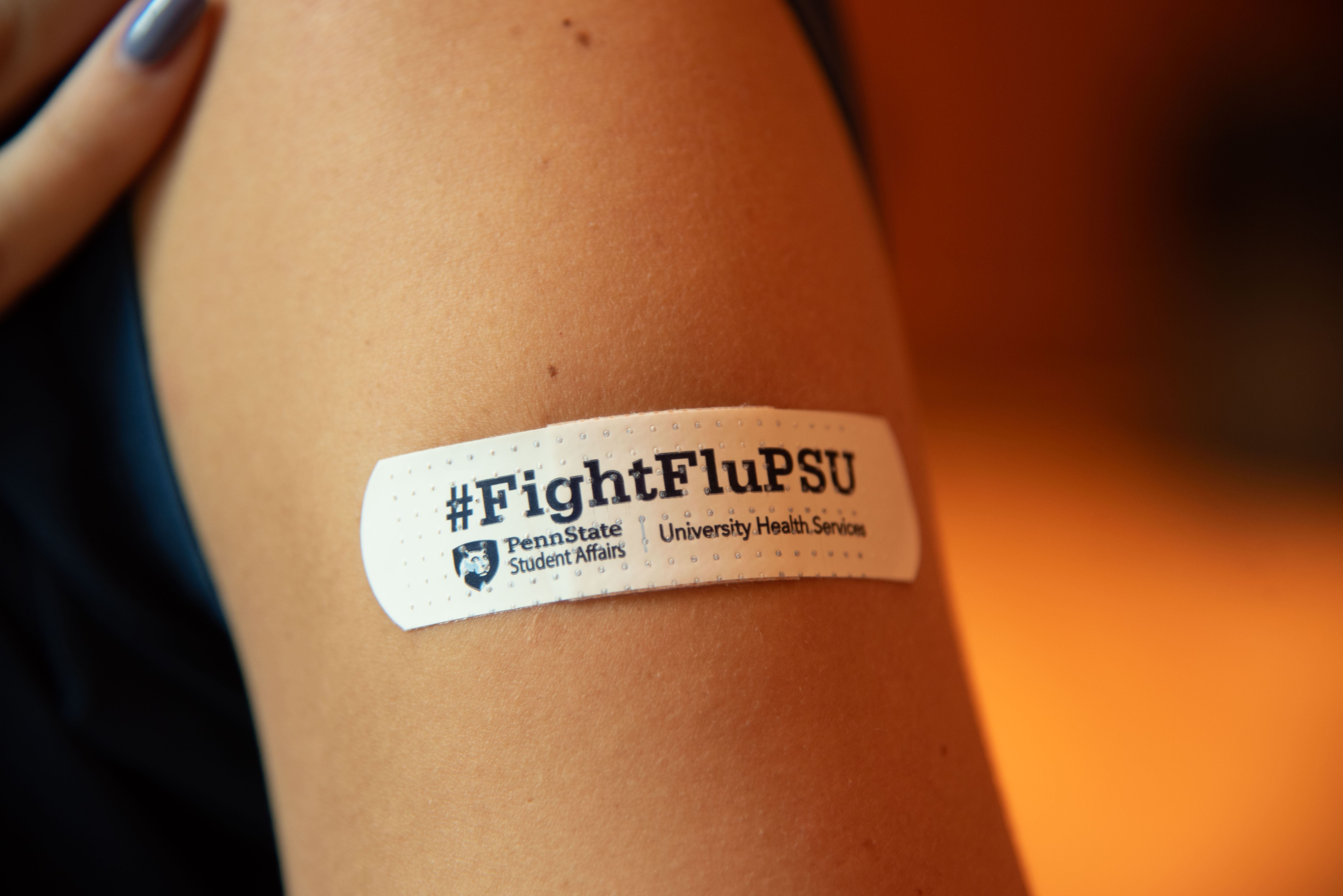 #FightFluPSU bandage on student.