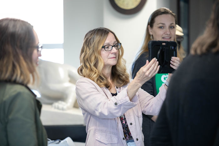 Individual holds tablet during augmented reality workshop