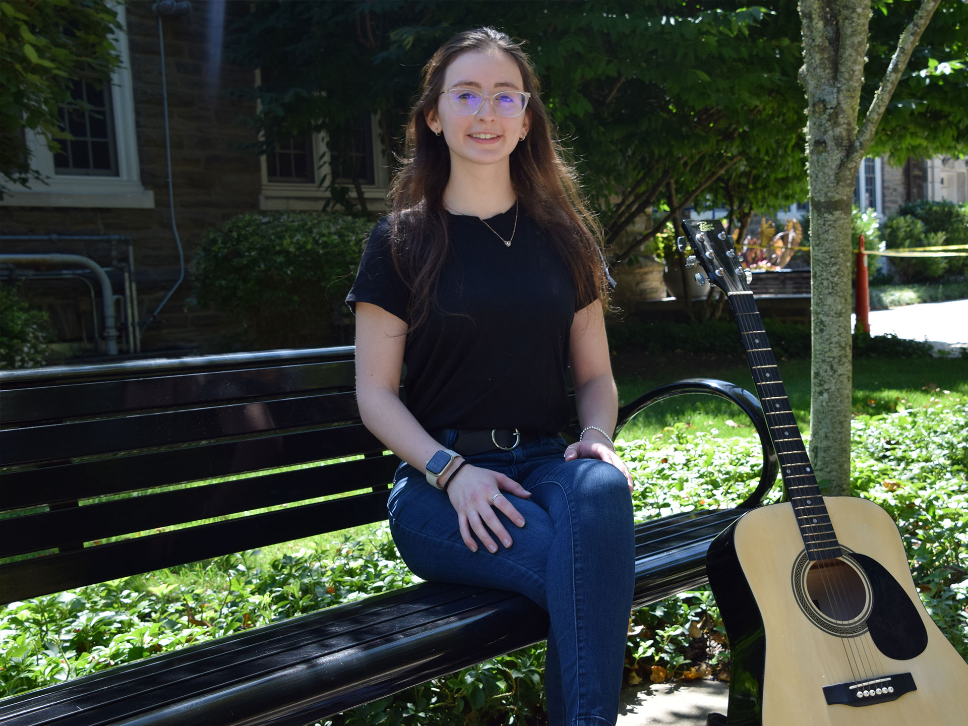 Penn State Abington graduate Vanessa Sexton posing with guitar