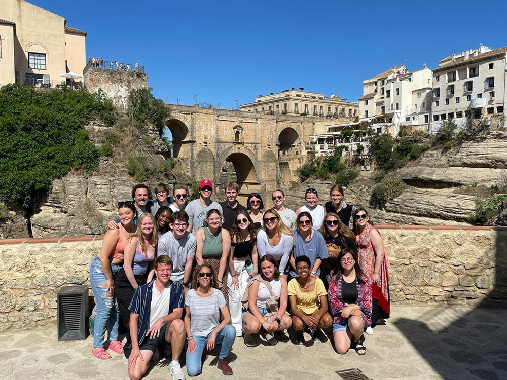 Students and faculty participating in the Spanish Language and Culture faculty-led course trip pose for a group photo together in Ronda, Spain.