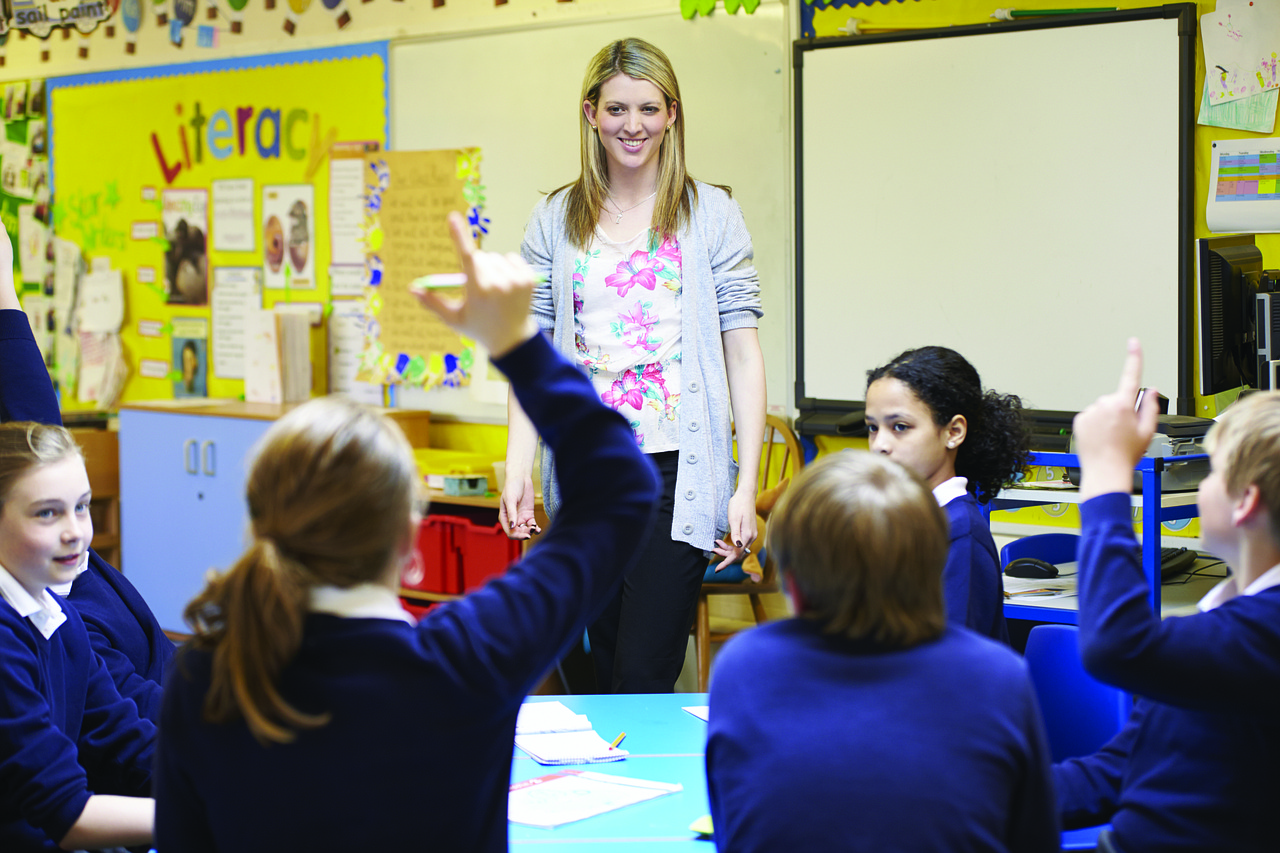 stock image of a teacher standing in front of a class of children