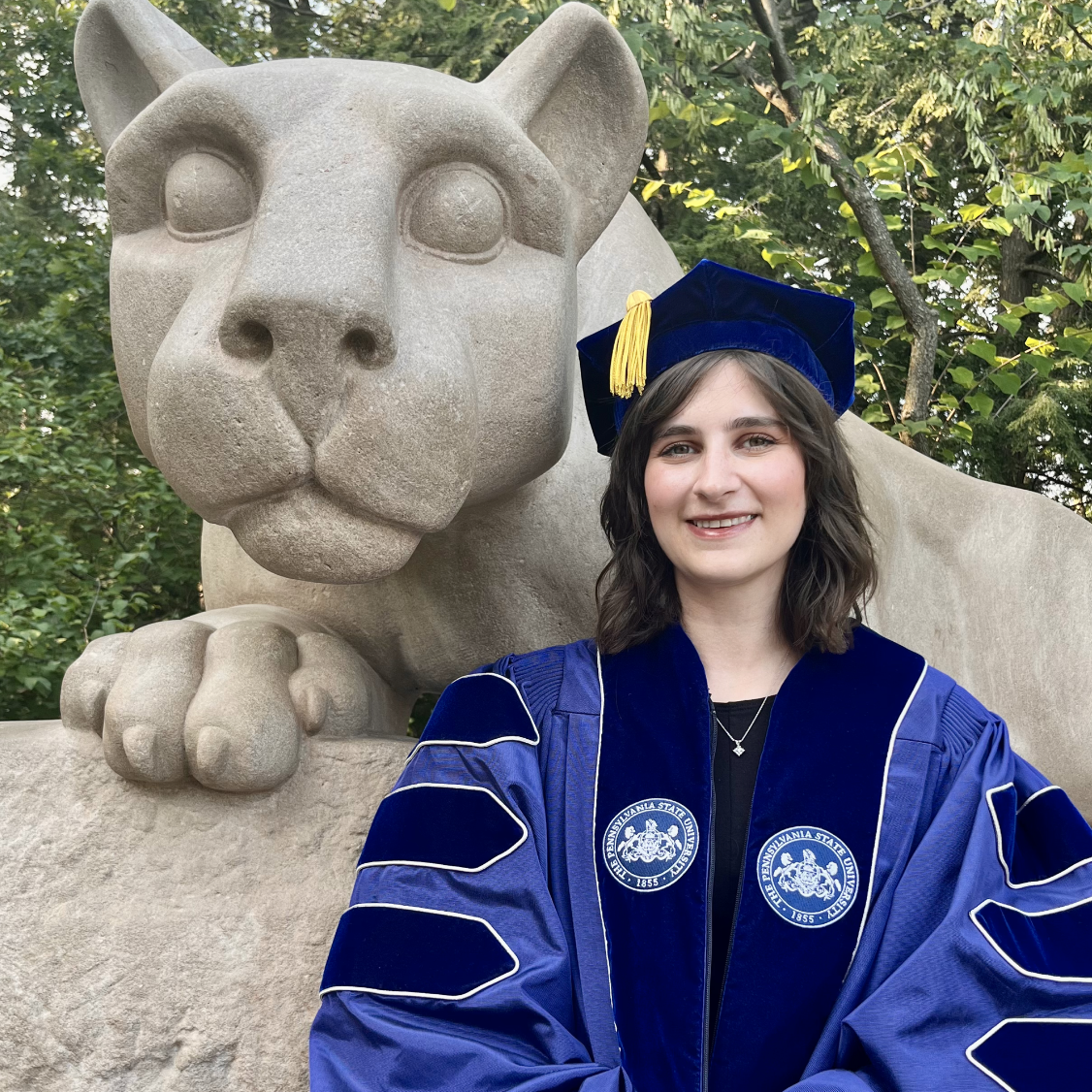 Headshot of Hannah standing in front of Nittany Lion statue 