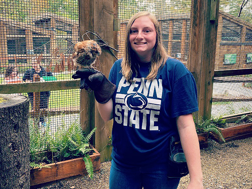 Student holding hawk