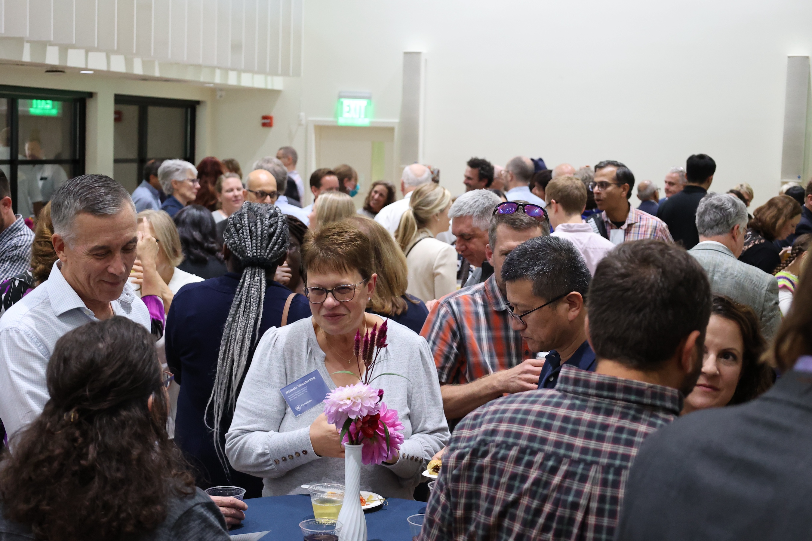 Faculty and families enjoying conversation at public event