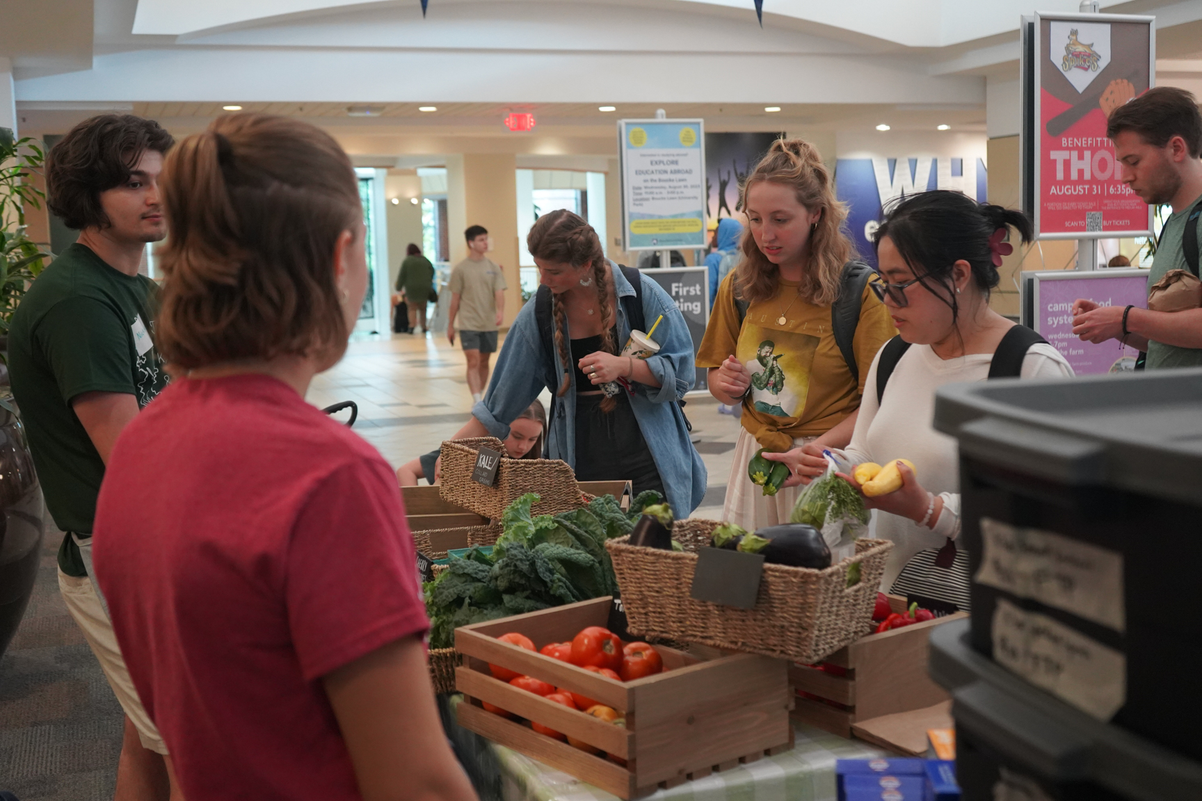 Students shop for fresh produce at the Feed the People farm stand in the HUB-Robeson Center