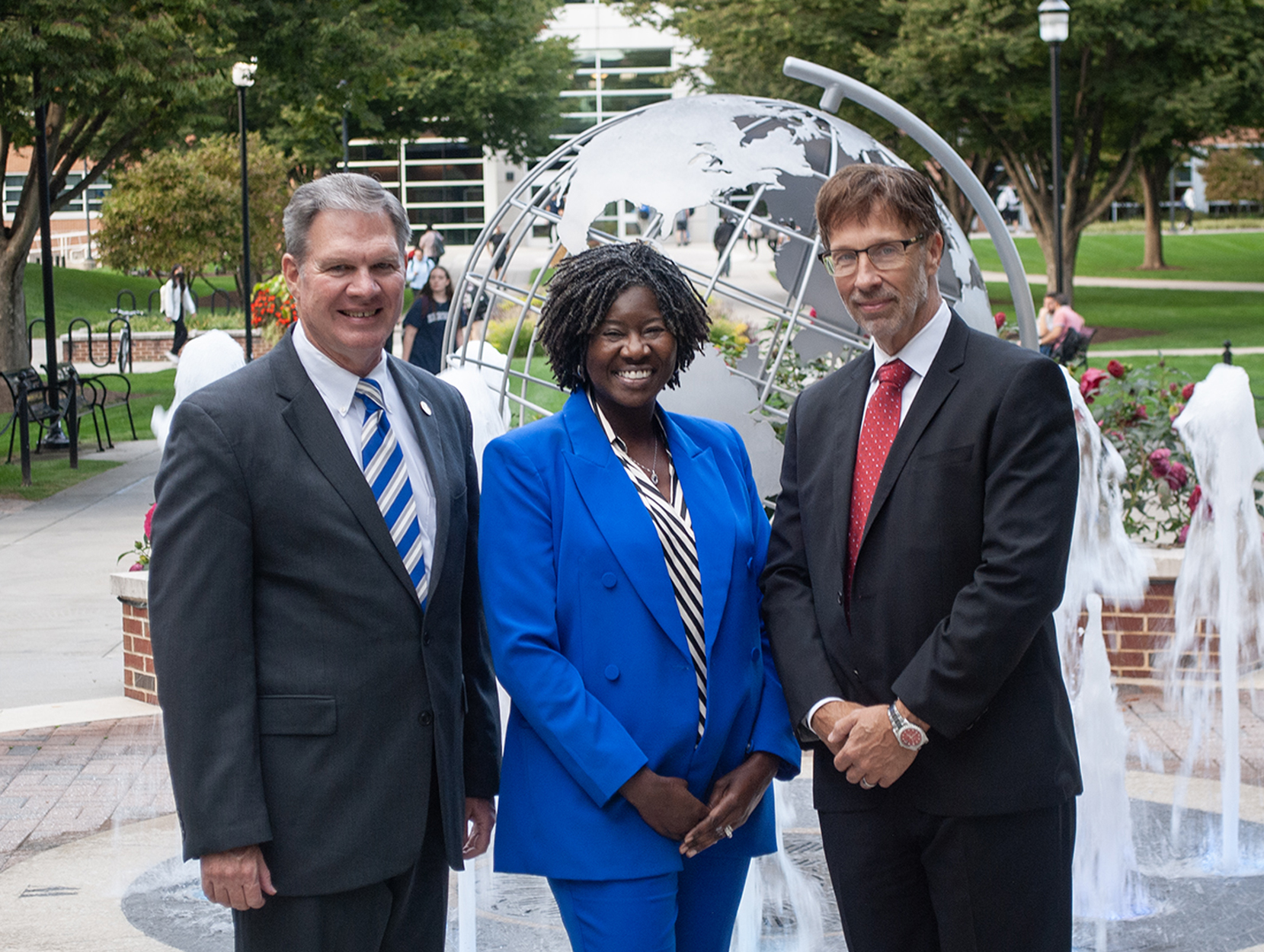 Group photo of three people on Penn State Harrisburg campus