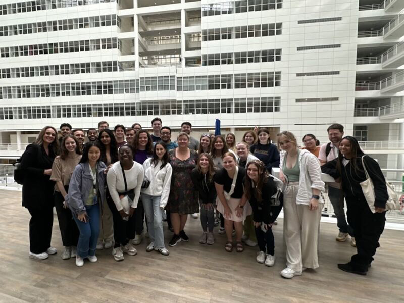 A group of Penn State students stands inside a building’s atrium in the Netherlands.