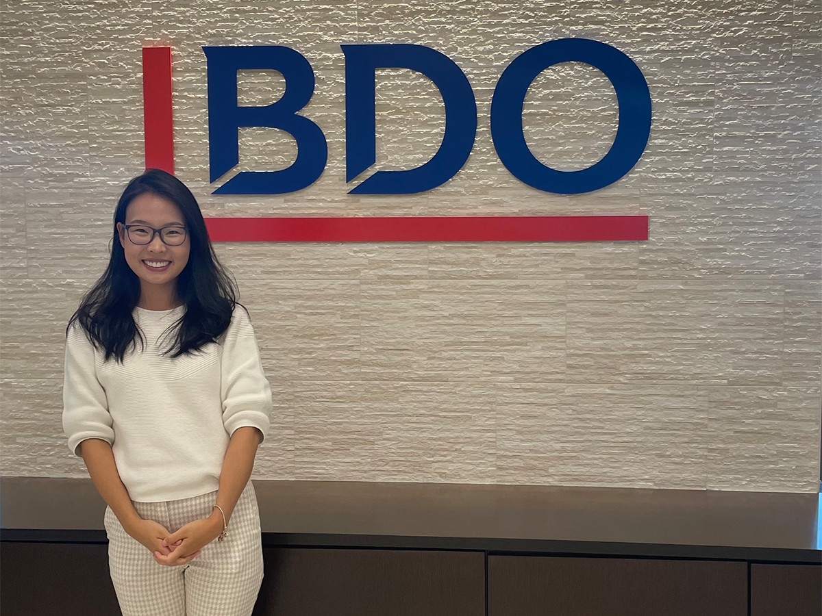 Bolortungalag Mijiddorj standing in front of a wall with the BDO logo