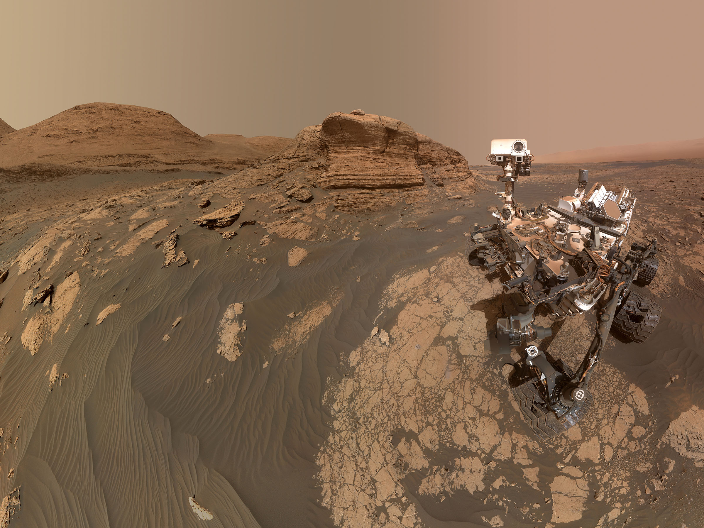 A robot rover pictured on a Martian landscape