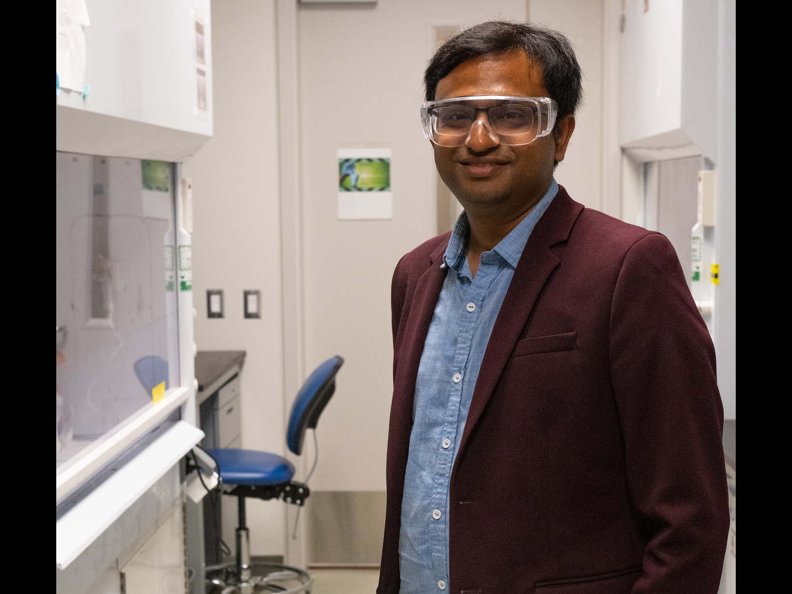 Person wearing lab goggles in a lab