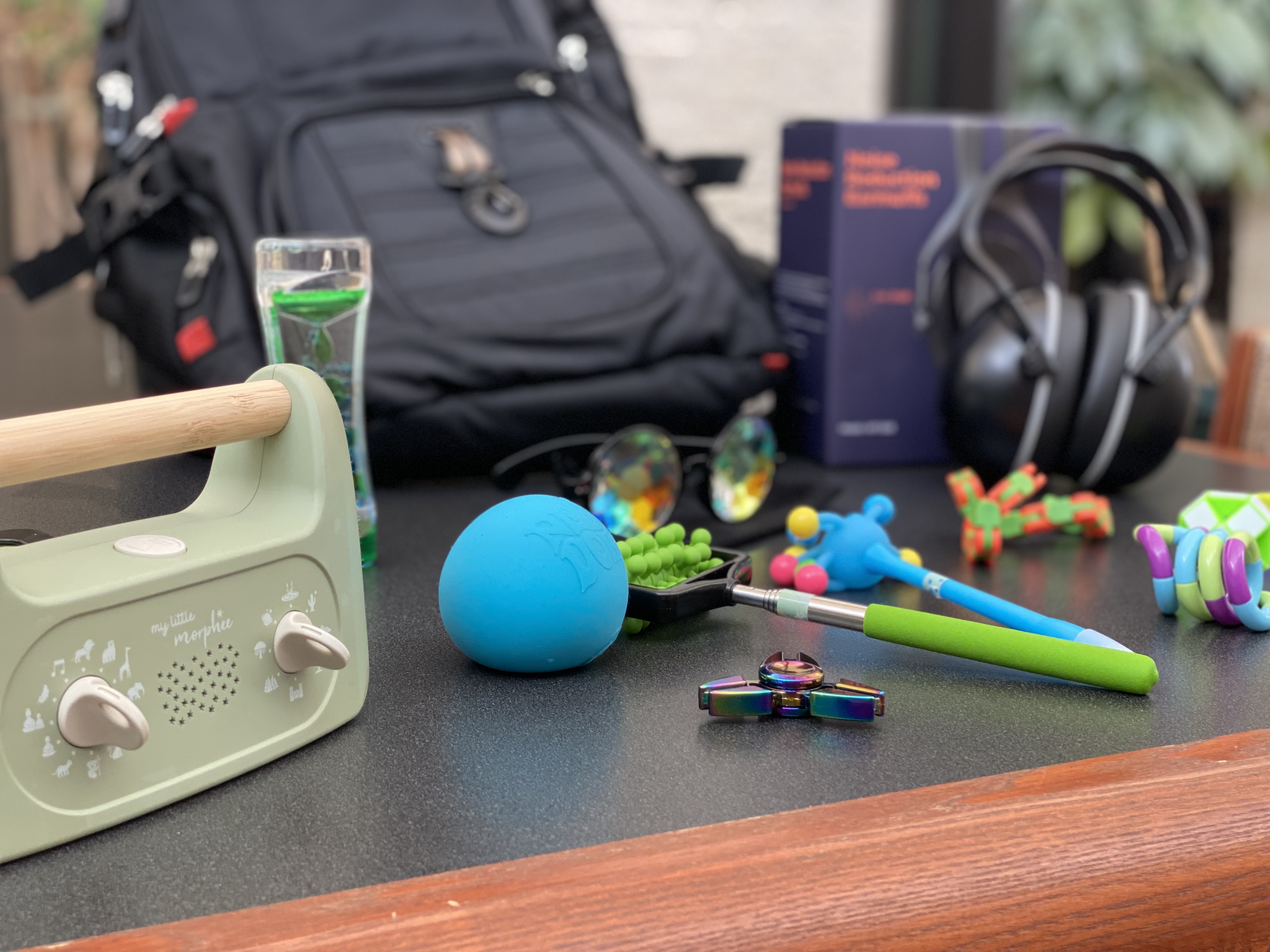 photo of black backpack with sensory tools surrounding it