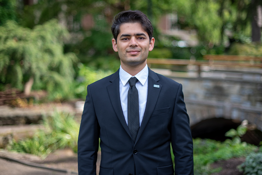 Younes Shekarian standing in garden smiling