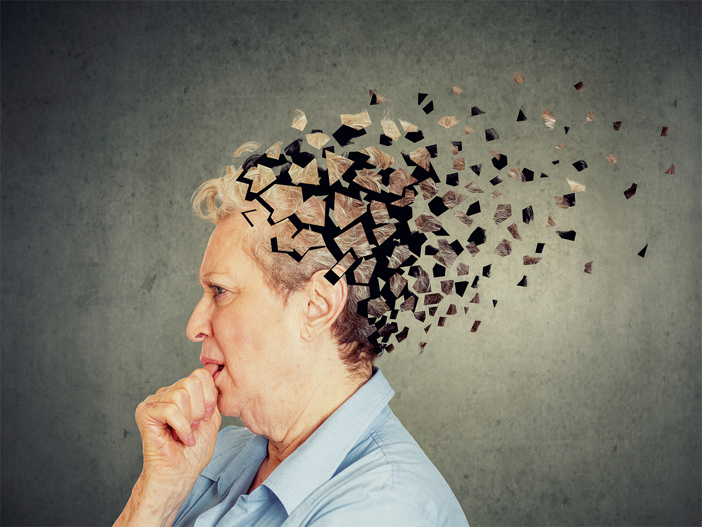 An older woman with a concerned look on her face. The back of her head is dissolving to suggest the loss of cognitive function