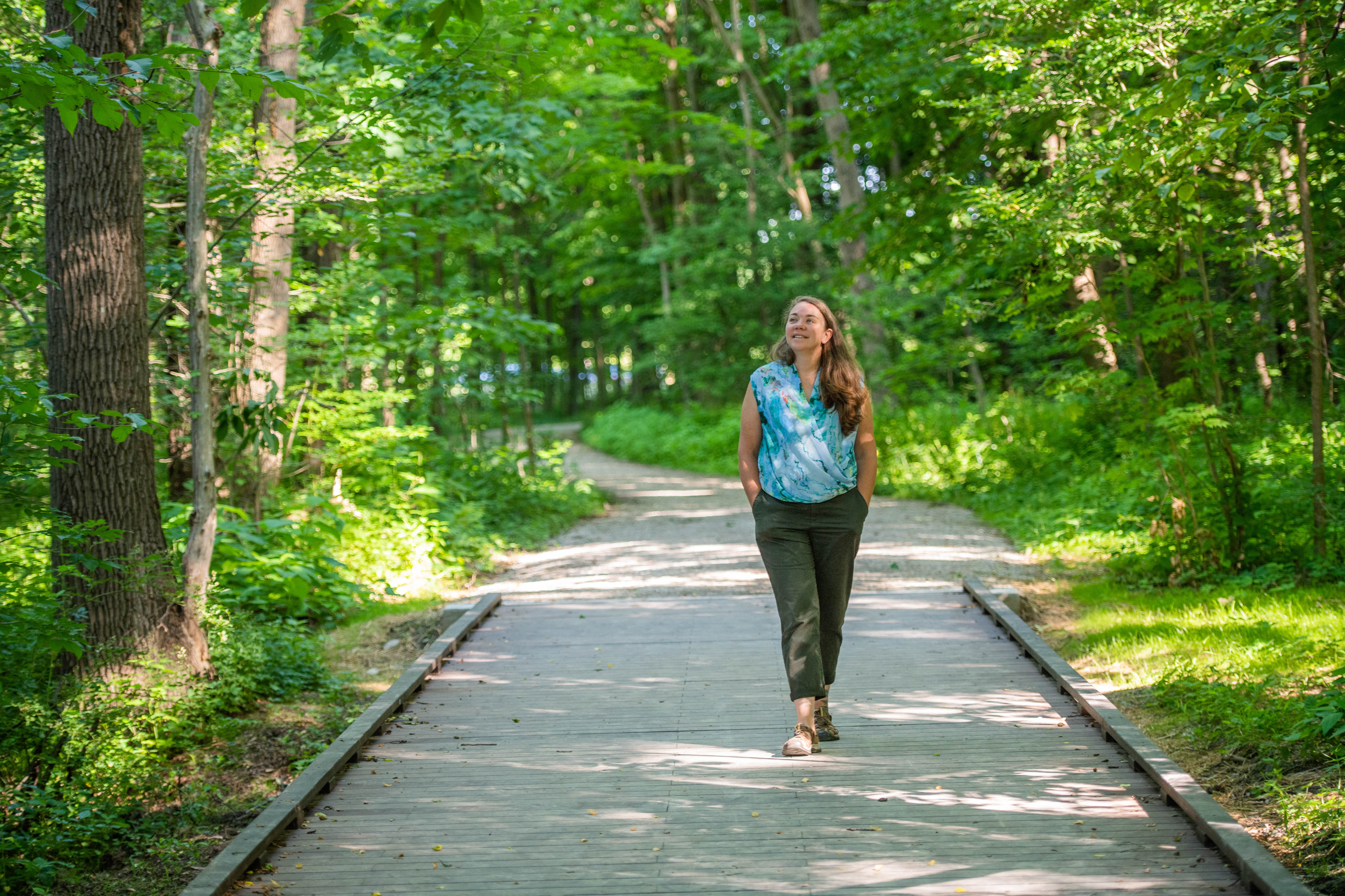 Sherri "Sam" Mason walks on a path through trees