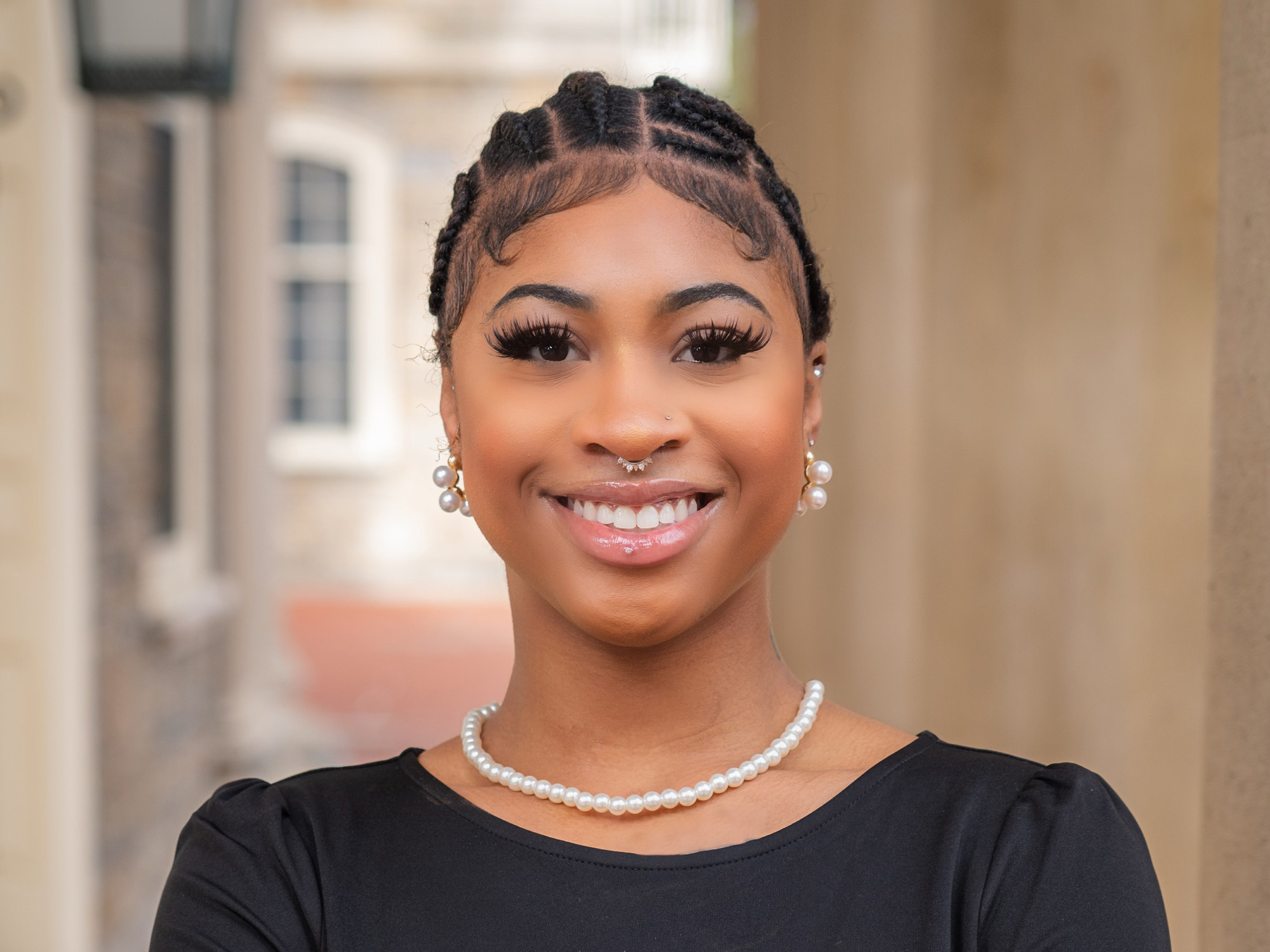 Brooklynn Jones, a third-year Liberal Arts student, stands in front of Old Main at Penn State University Park.