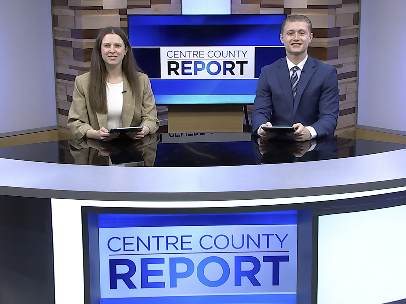 Two students at a TV news desk