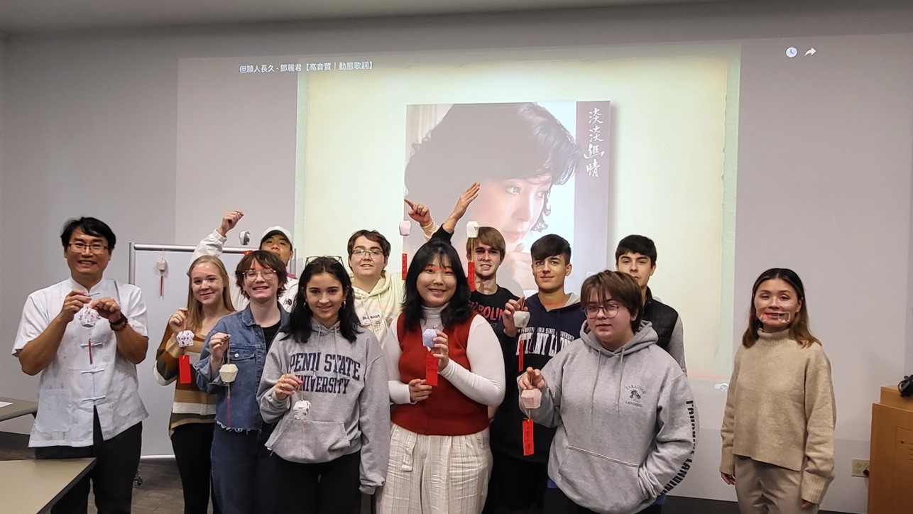 A group of students in front of a projected image of a face