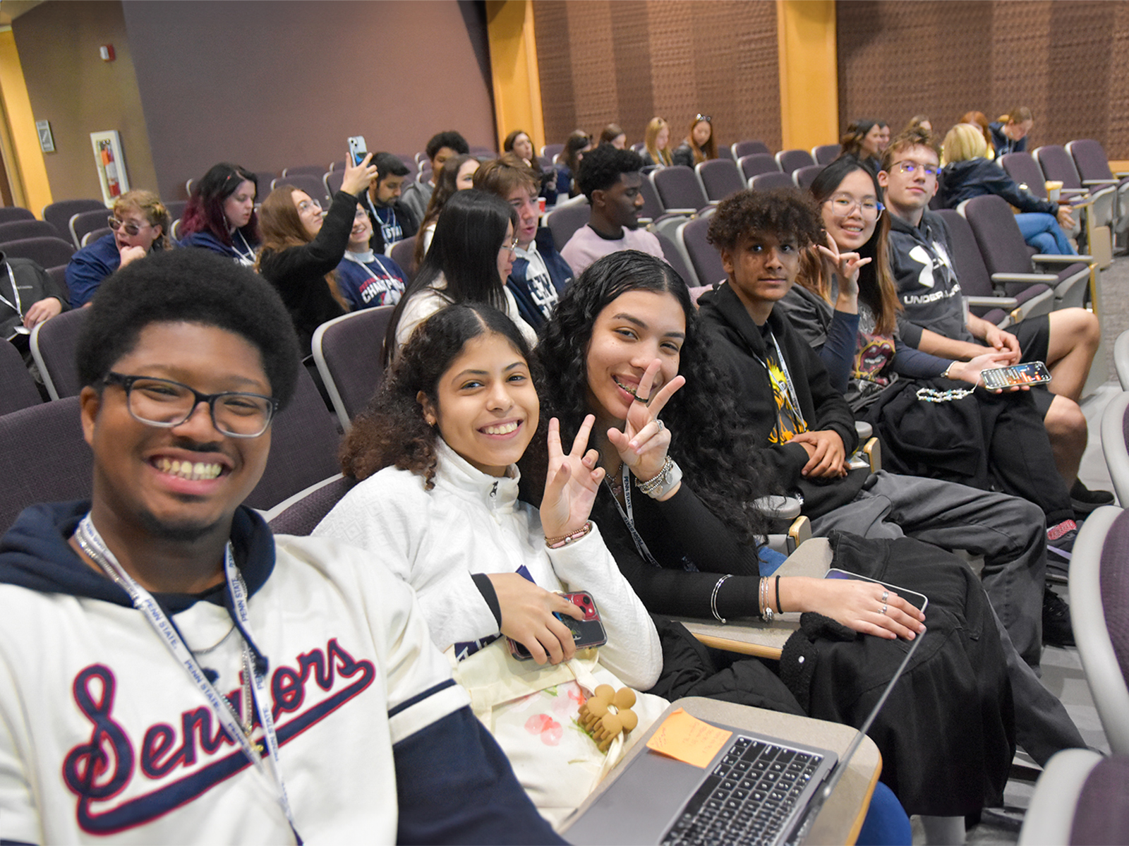 Male and female students sitting in an auditorium