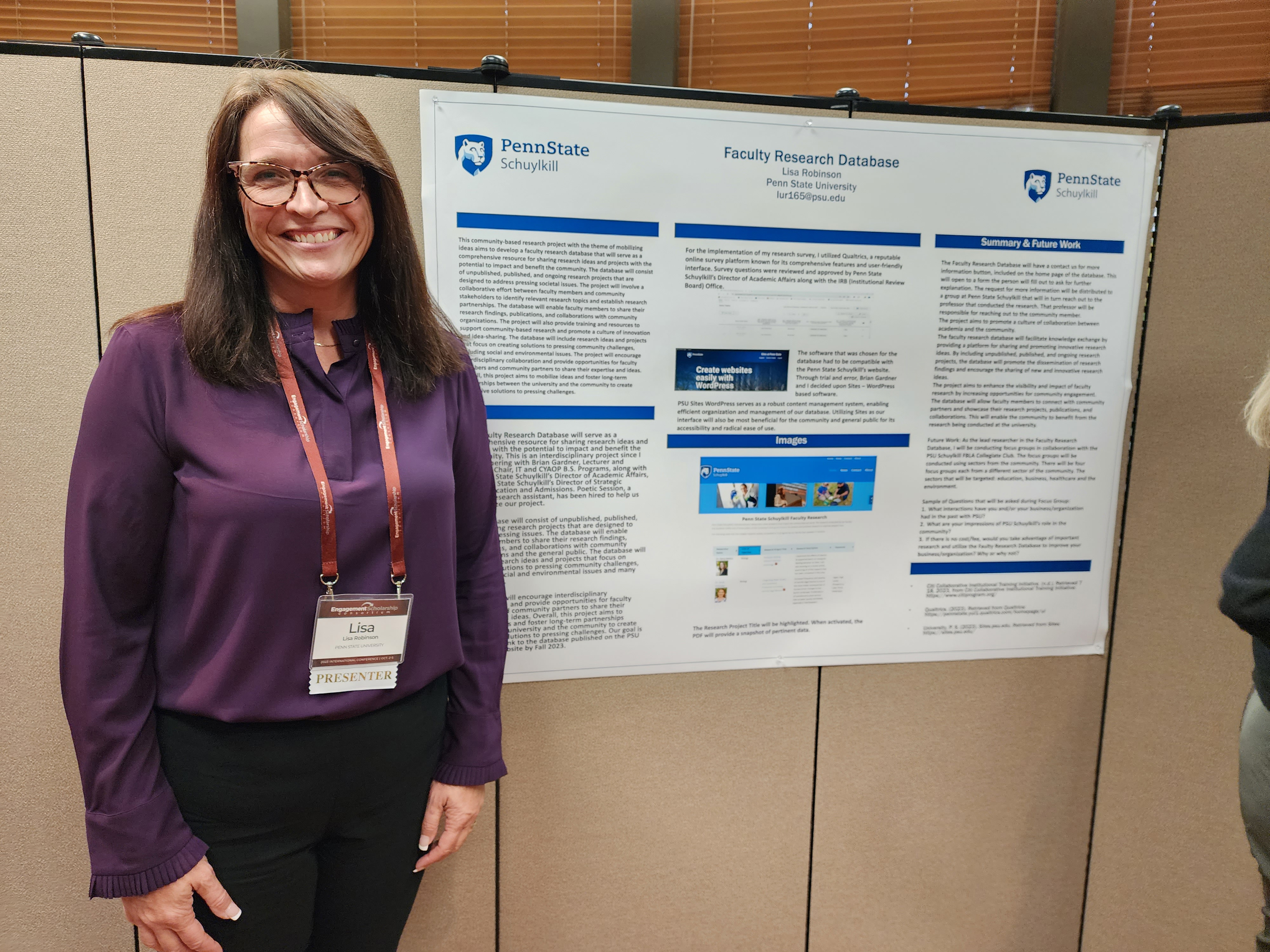 Person poses with a research poster in auditorium.