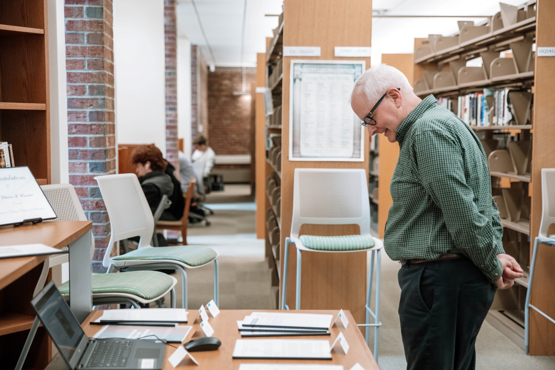 Professor looks at papers on table