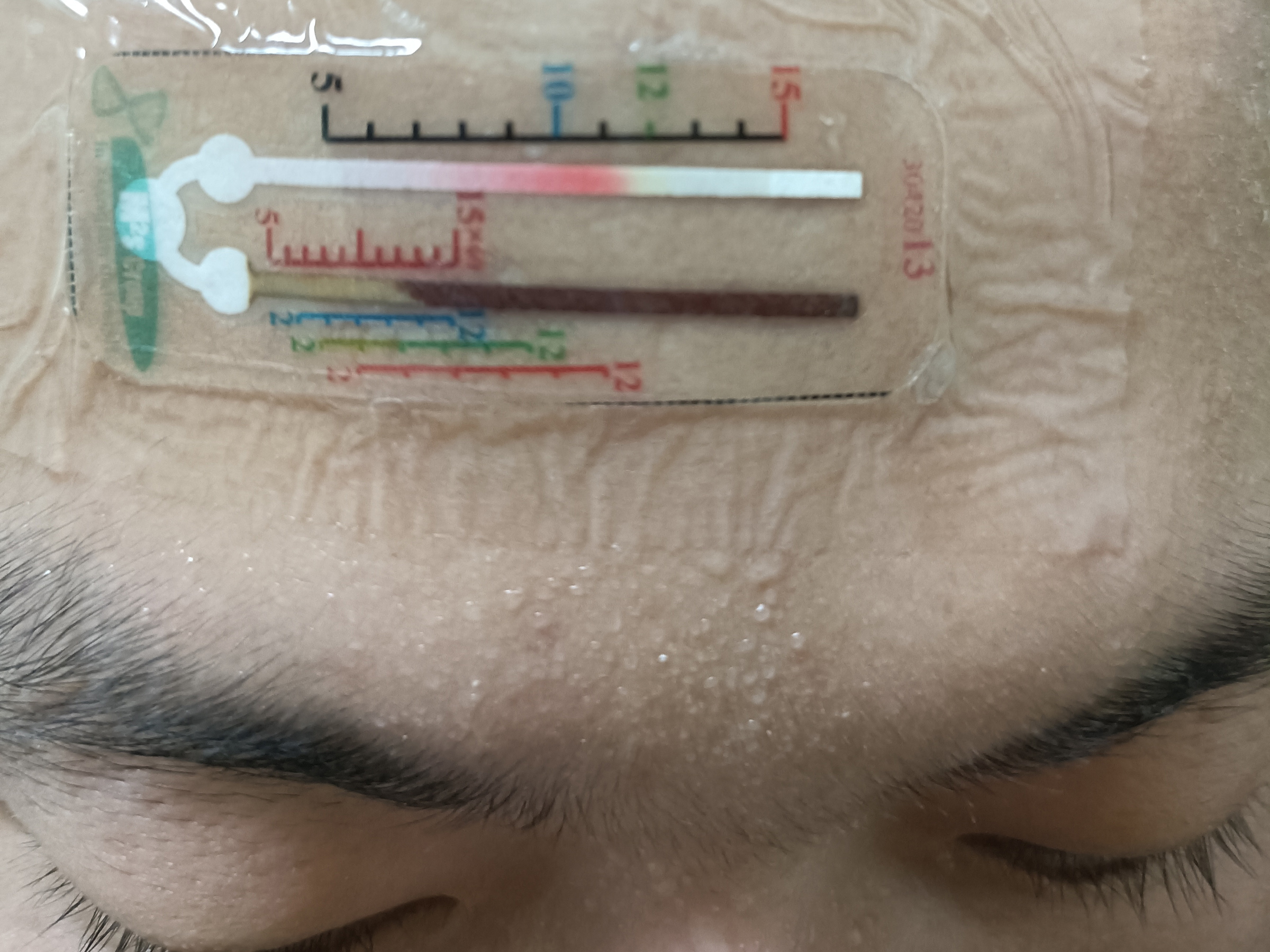 A sensor attached to a person's forehead