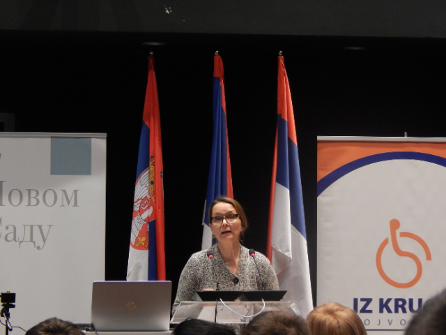 A woman standing behind a podium 