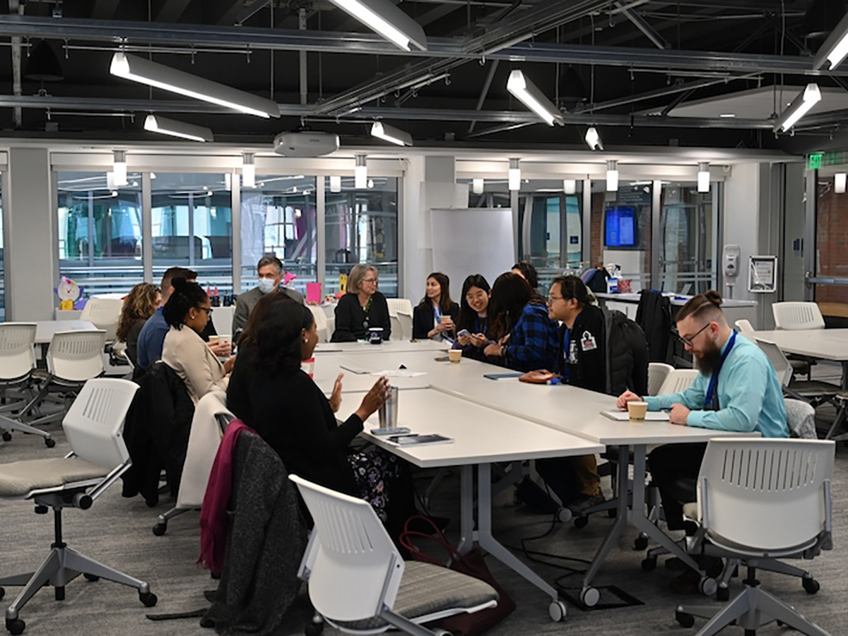 Group of people sitting around a conference table