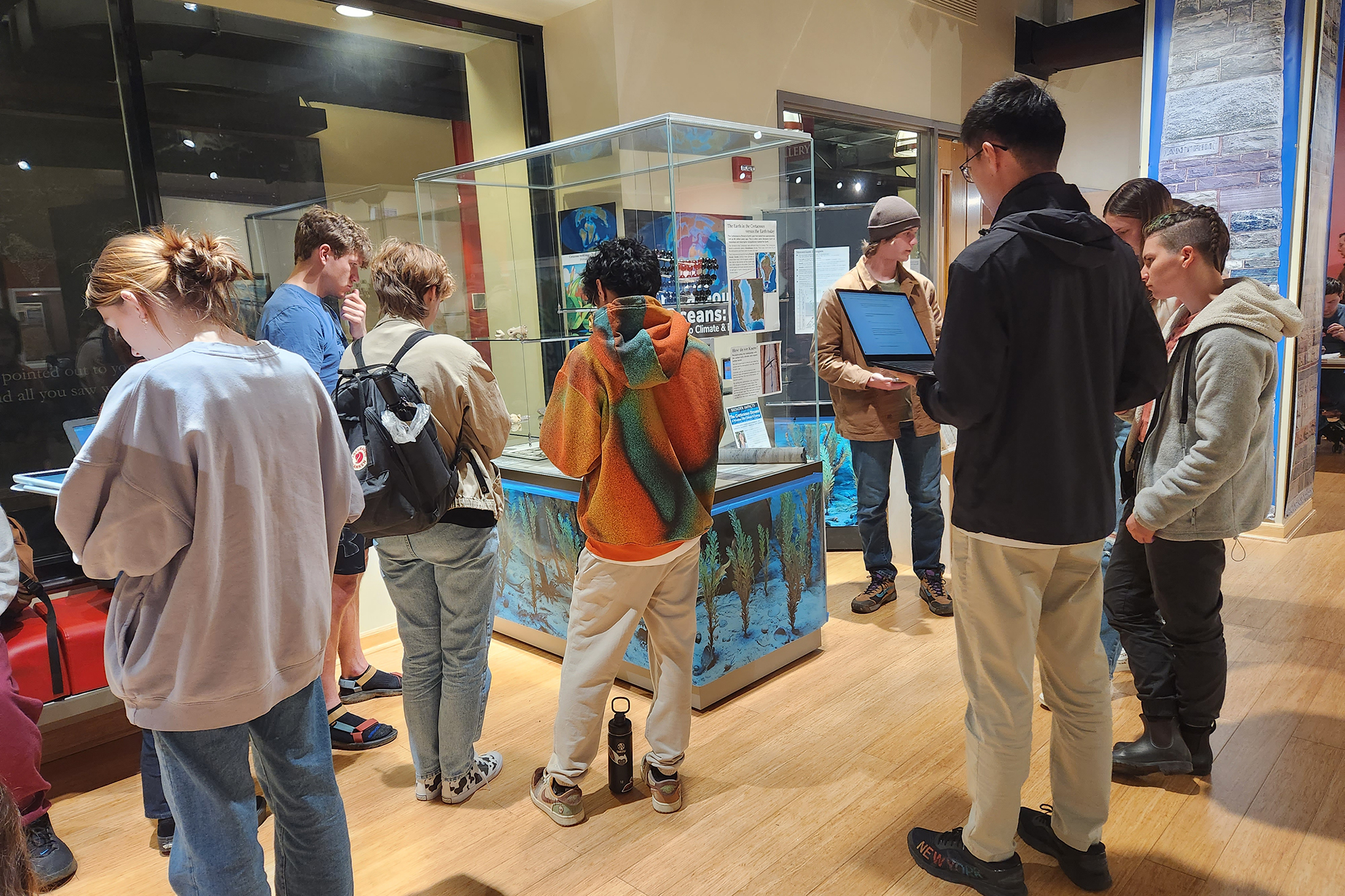 Students tour the EMS museum exhibit titled "Cretaceous Oceans and Climate."