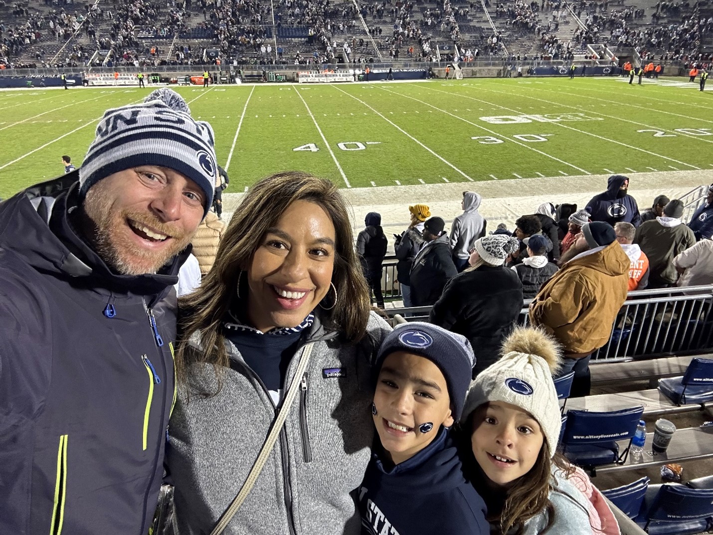 smiling family at college football game