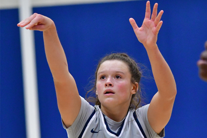 Penn State Behrend basketball player Morgan Altavilla holds her hands up after taking a shot.