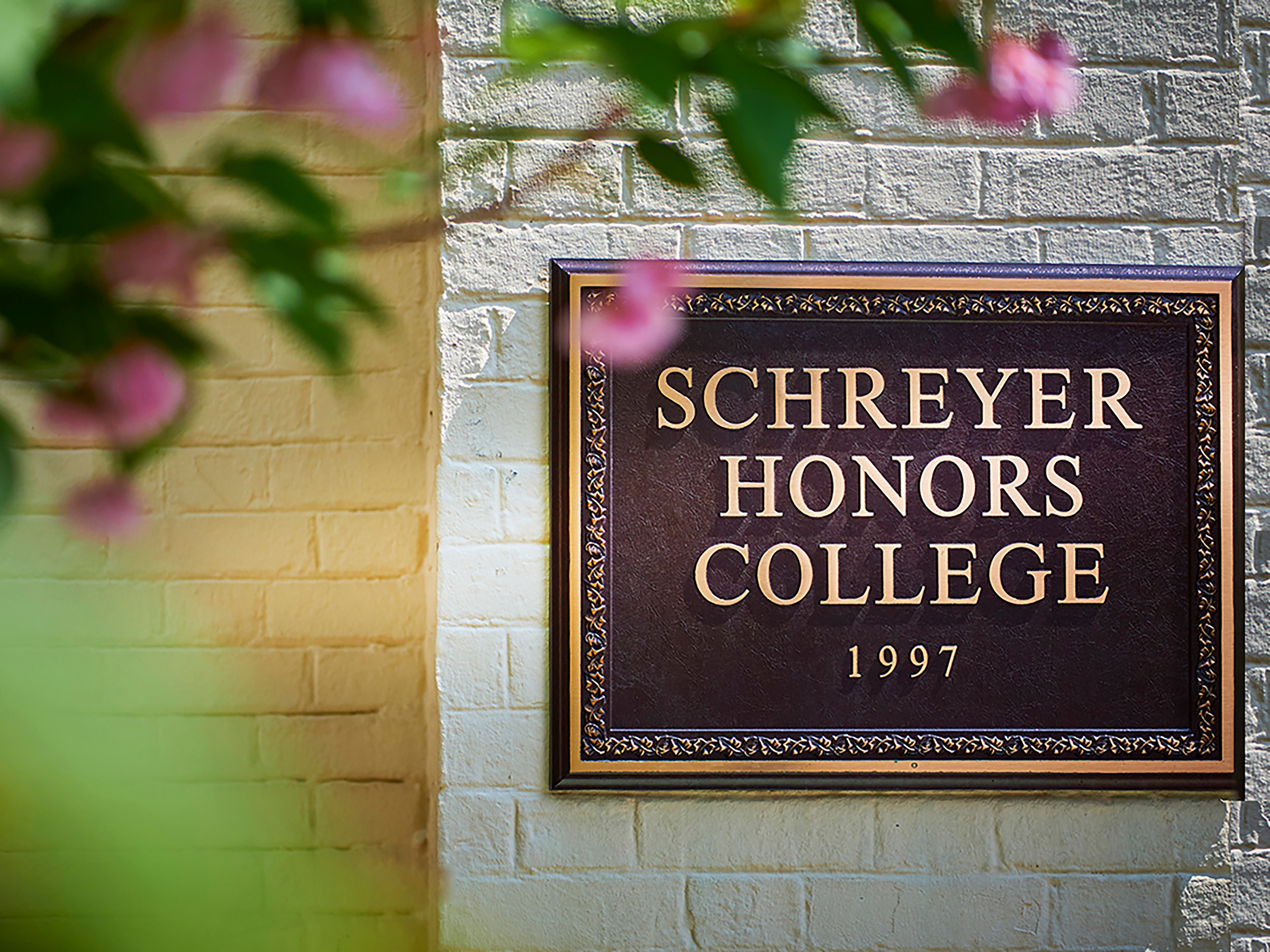 a plaque that reads Schreyer honors college 1997