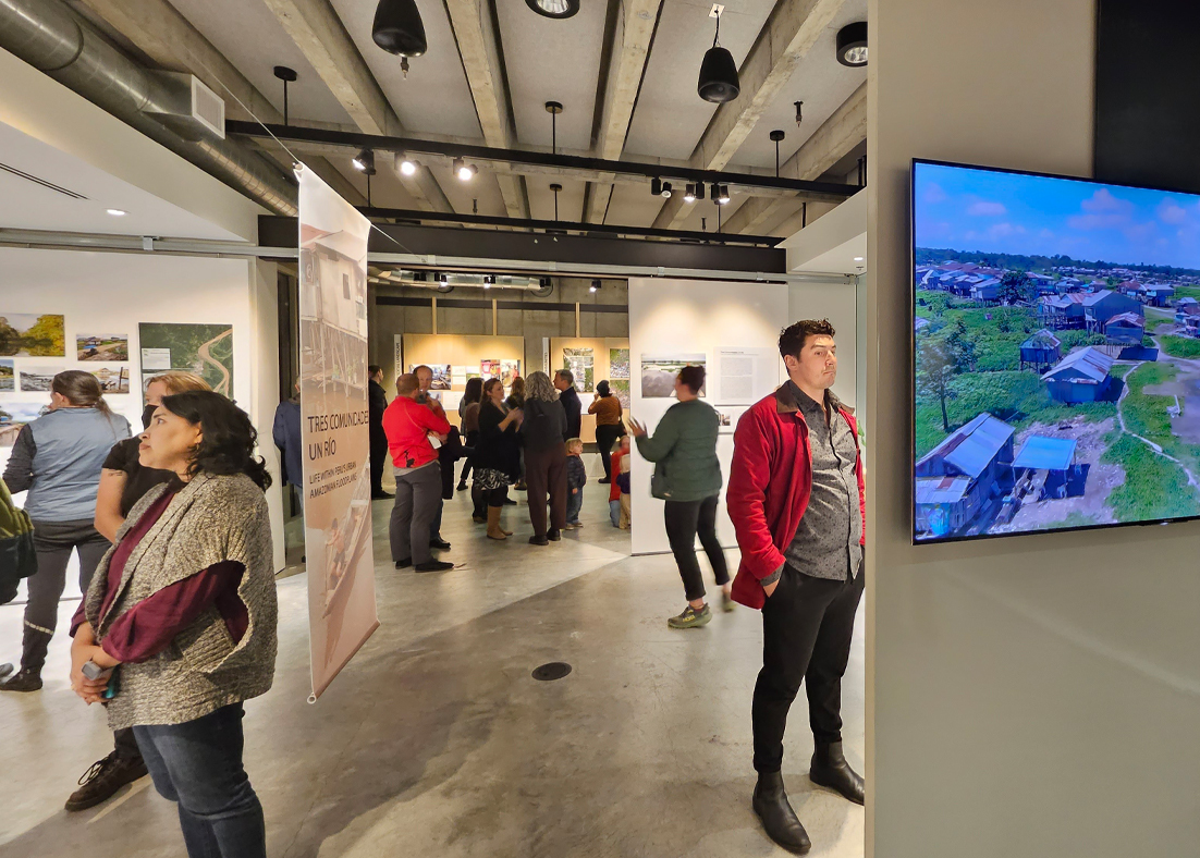 A group of people observe an exhibit at the University of Washington Gould Gallery. 