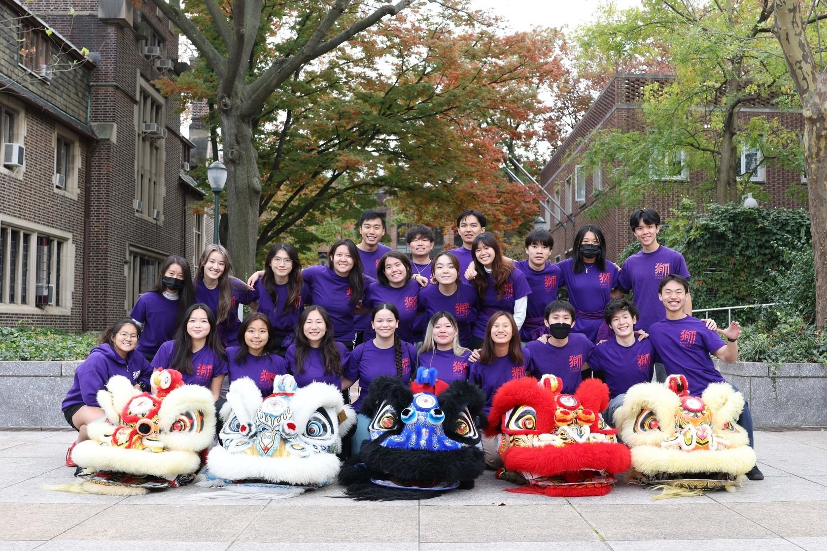 Group of students in purple shirts smiling