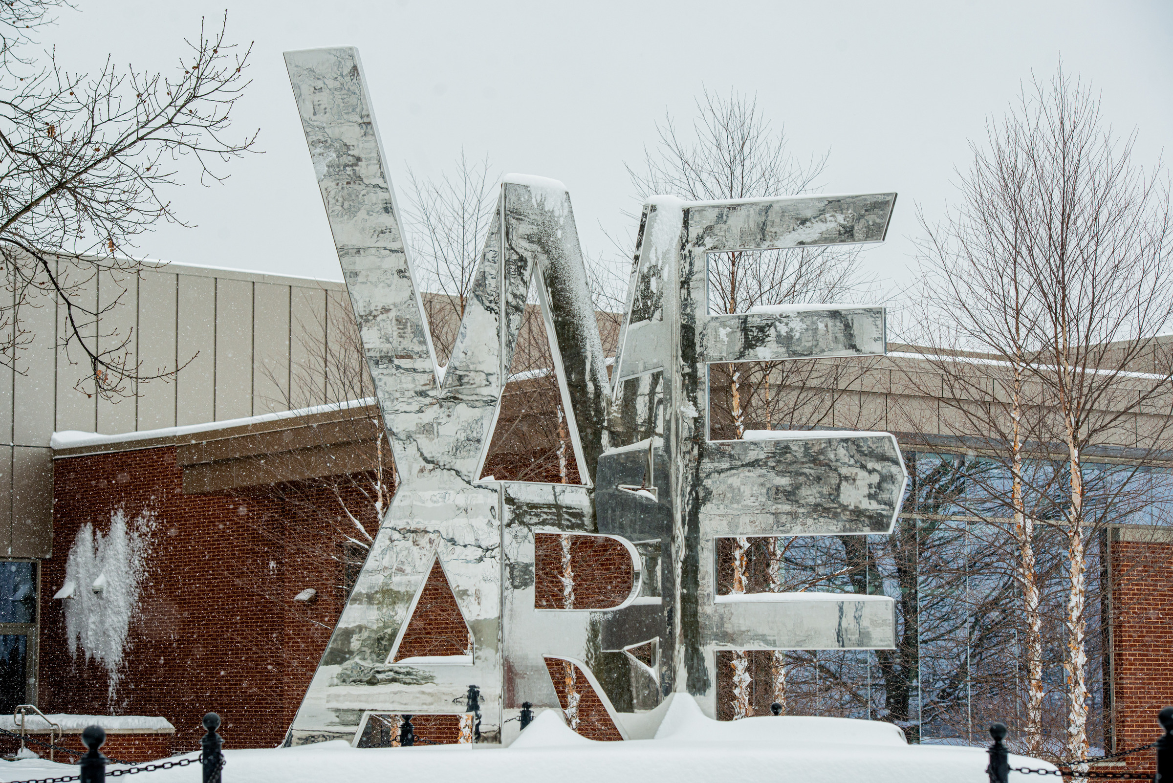 We Are sculpture at University Park campus in the snow